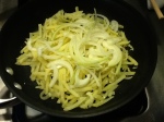 Adding the Onions on Top of the First Half of the Potatoes